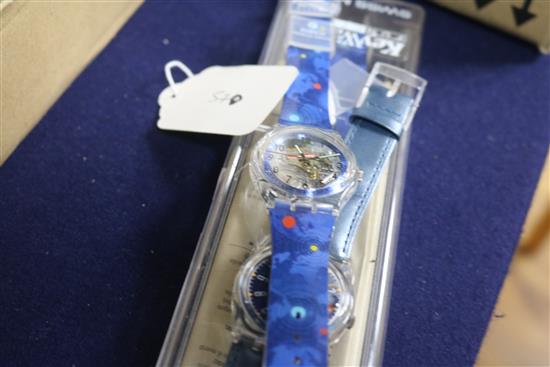 Three assorted Swiss Swatch wrist watches.